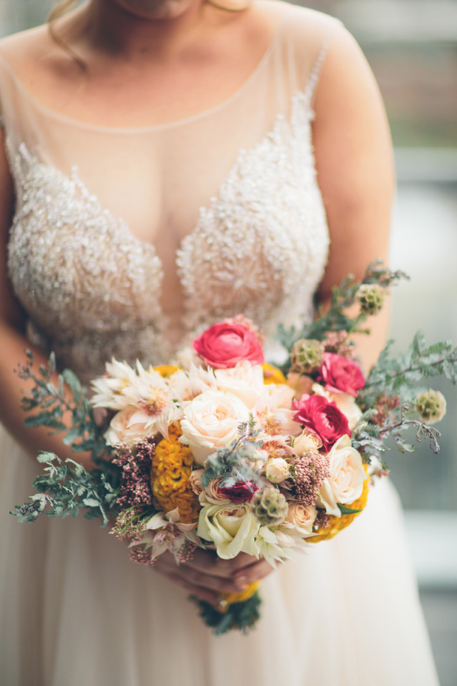 Bride holding a vibrant wedding bouquet