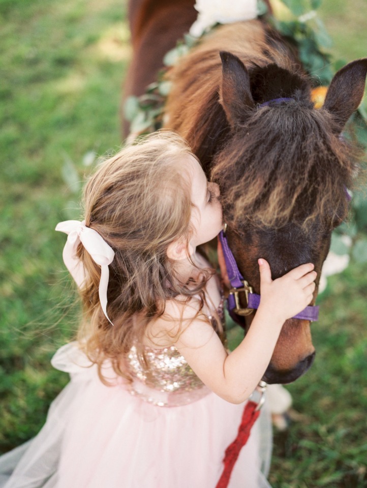 cute little flower girl loving this sweet little pony