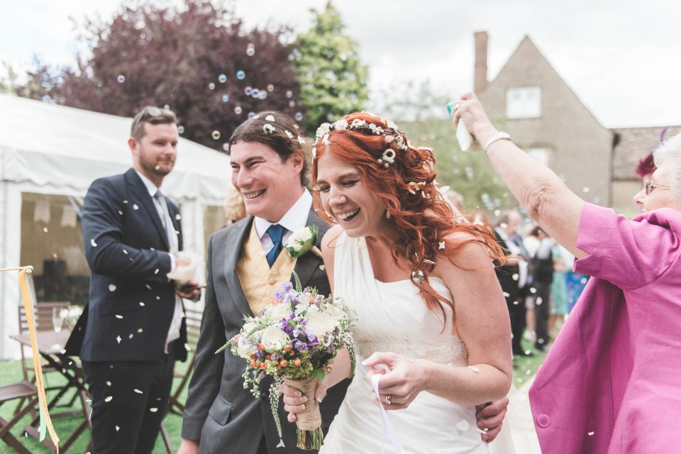 Happy bride and groom exiting wedding ceremony