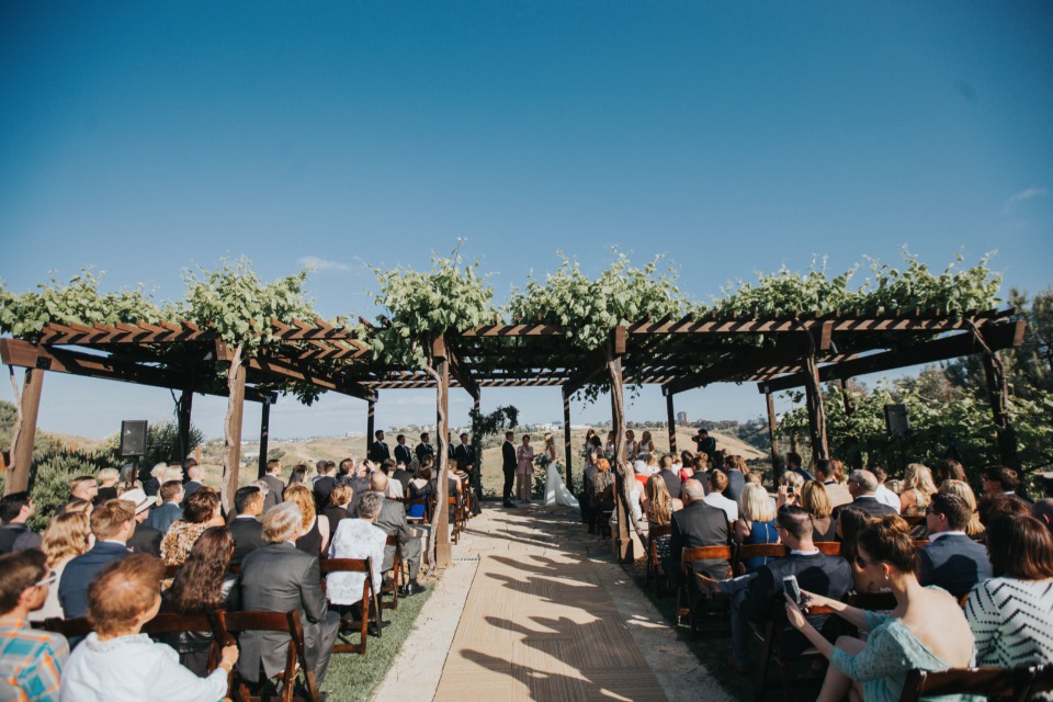 elegant wedding under the arbor at Green Acre Campus Point