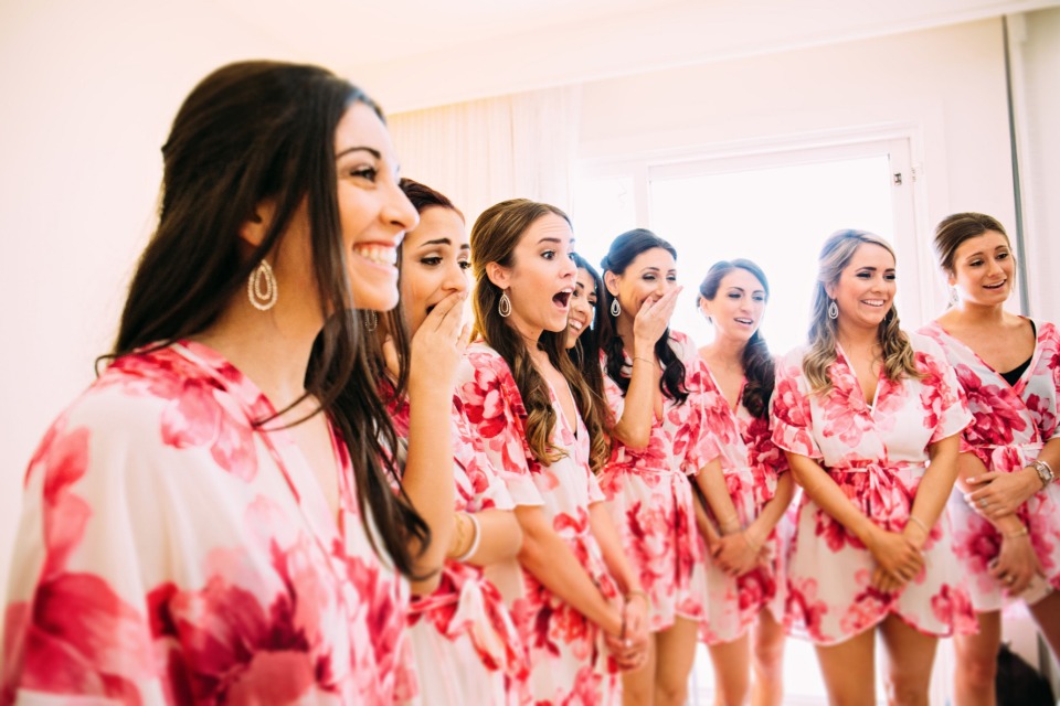surprising her bridesmaids with a first look at the wedding dress
