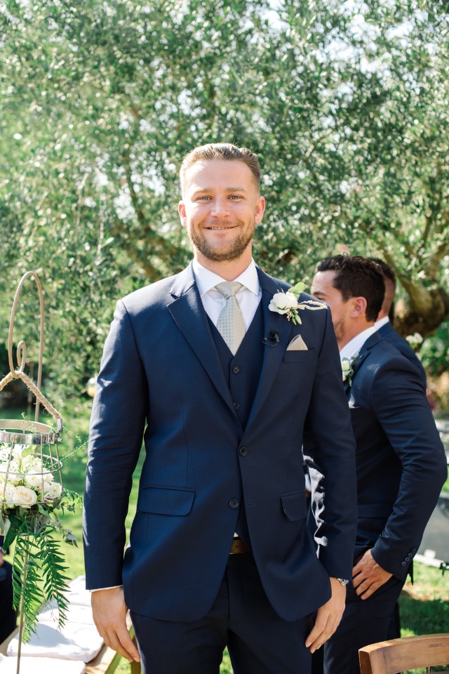 groom in three piece navy suit and grey tie