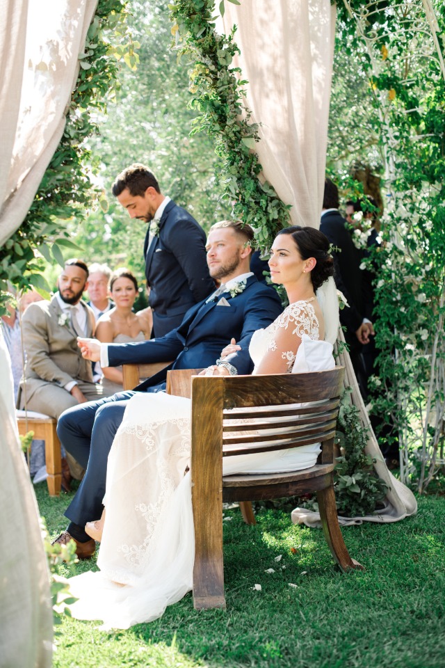 bride and groom seated wedding ceremony