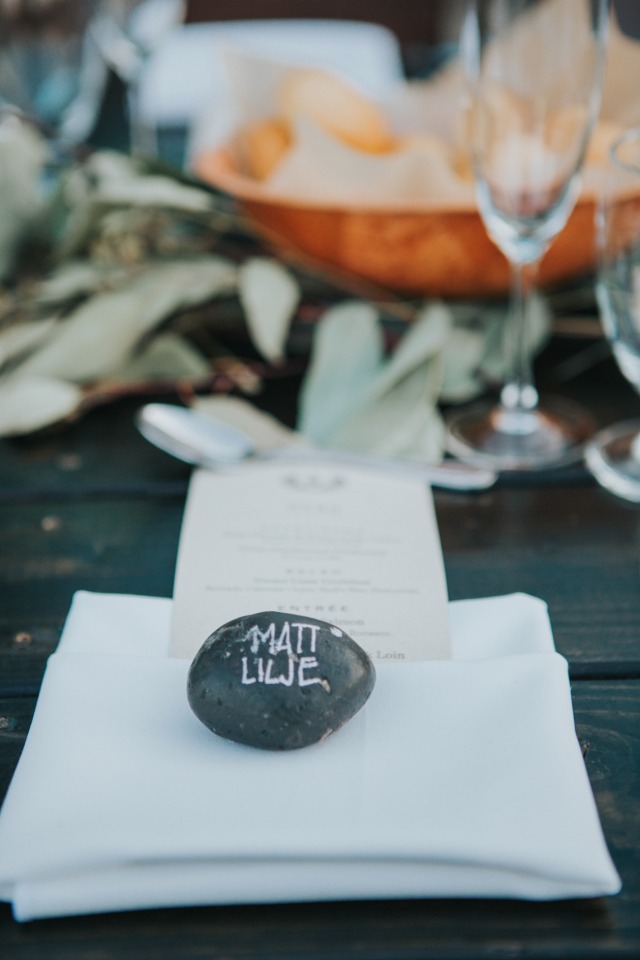 simple and elegant place setting with river stone escort card