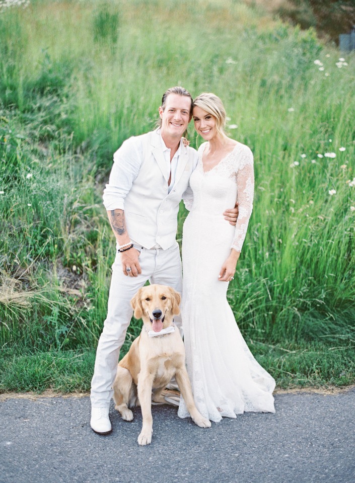 all white wedding couple with their furry little ring bearer