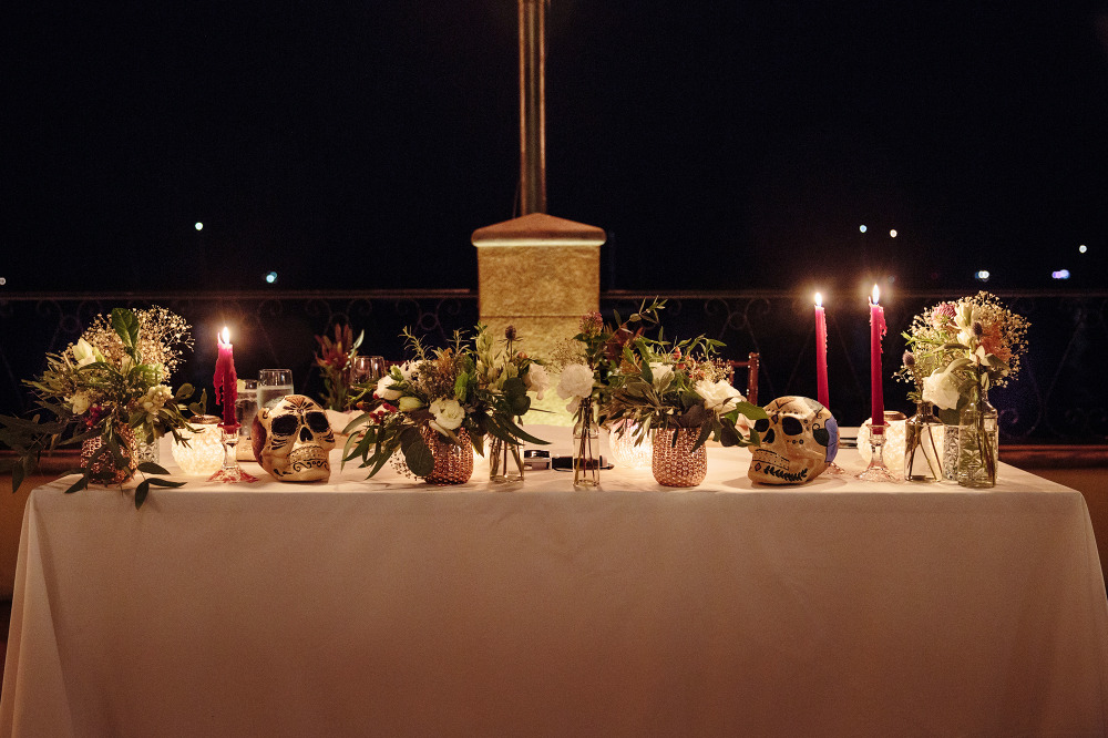 wedding sweetheart table with Mexican painted skulls