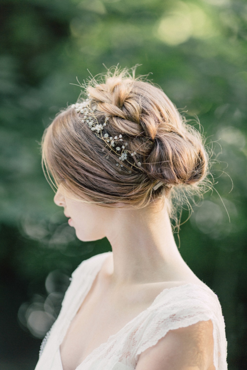 Elegant braided wedding hairstyle with delicate flowers