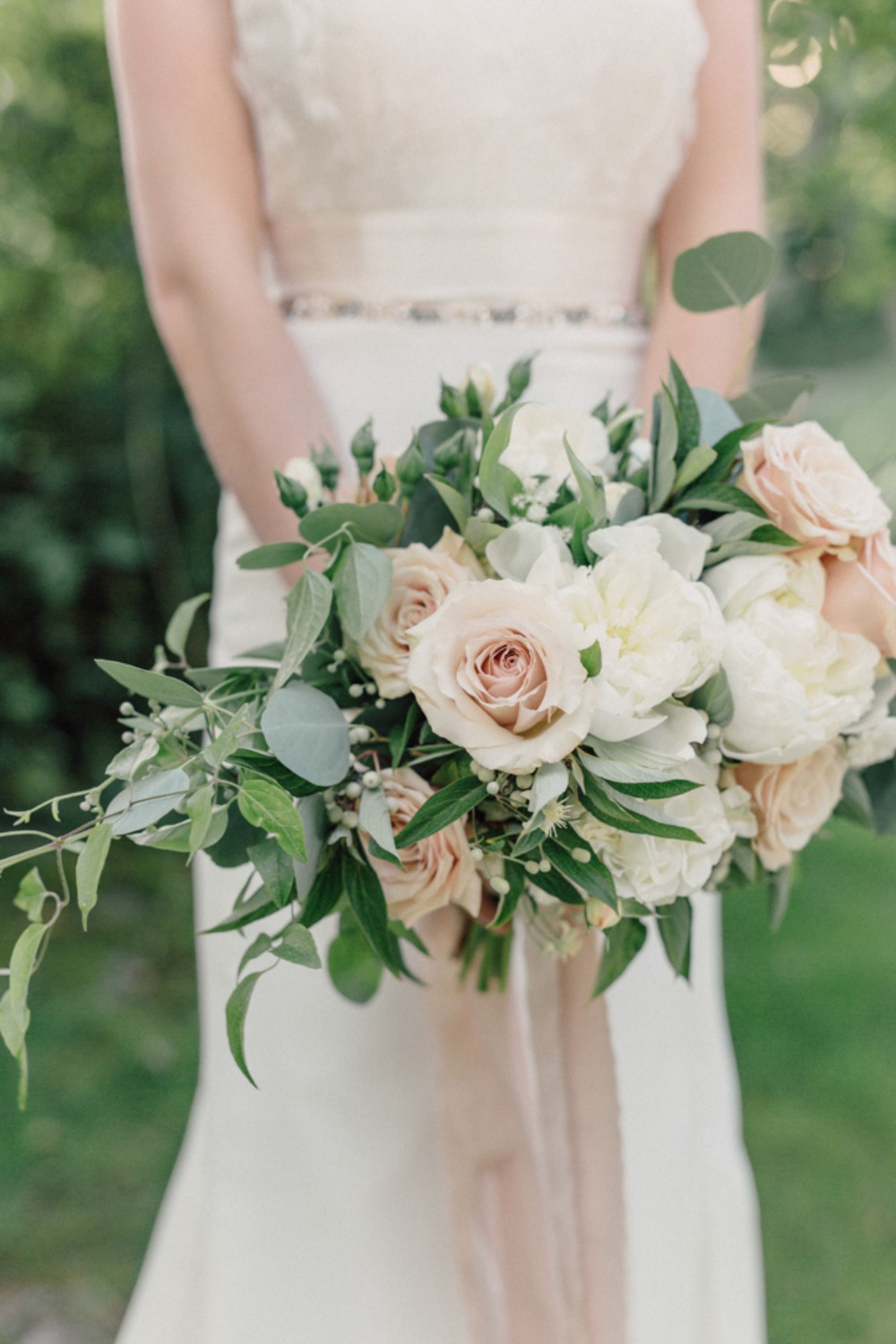 Bridal bouquet of cream and blush roses and peonies