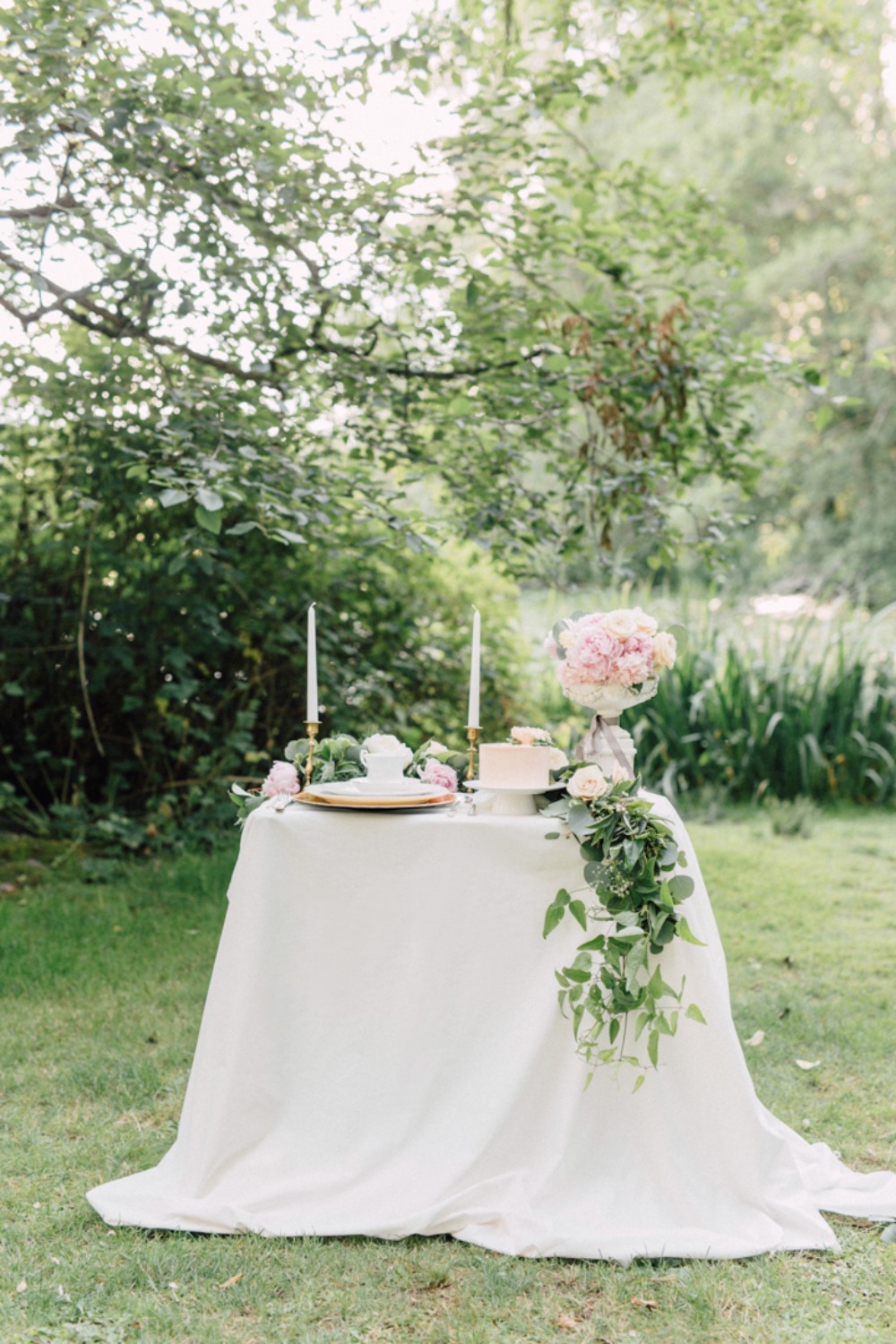 Romantic garden table setting with flowers and candles