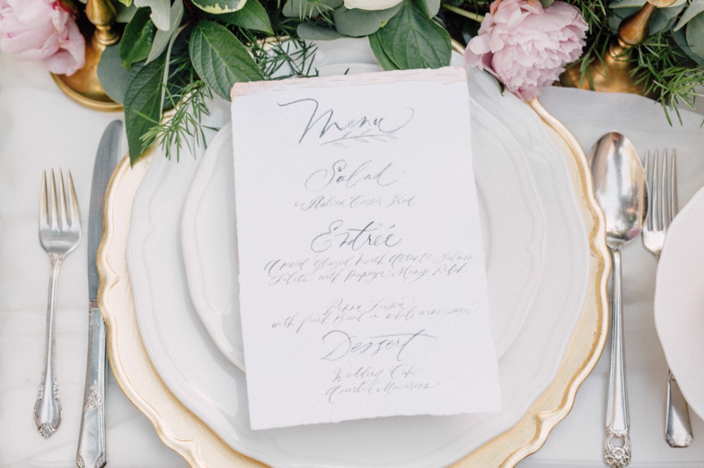 Elegant wedding table setting with floral menu card