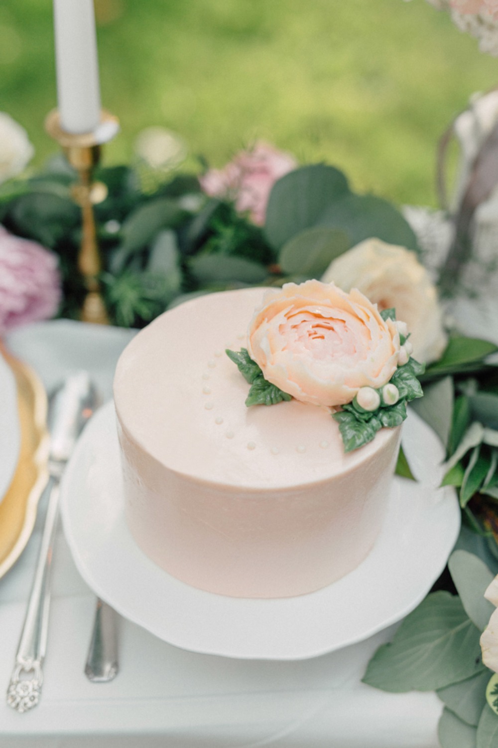 Pink celebration cake with flower decoration on table