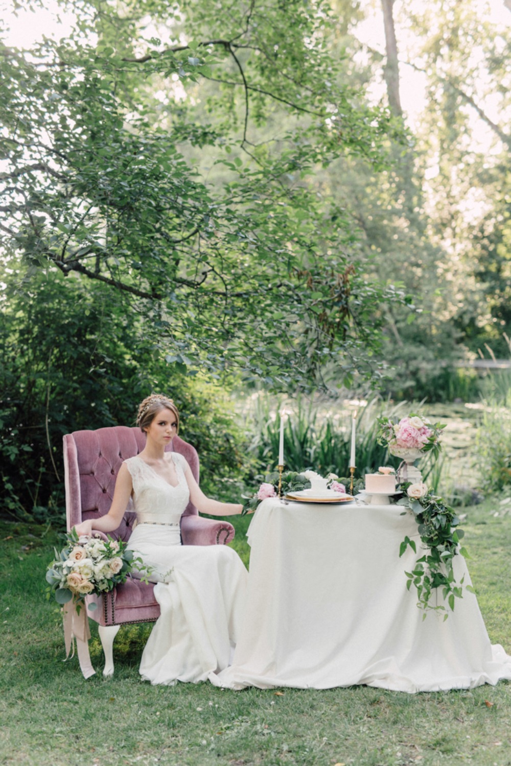 Elegant bride in pink chair at garden wedding table