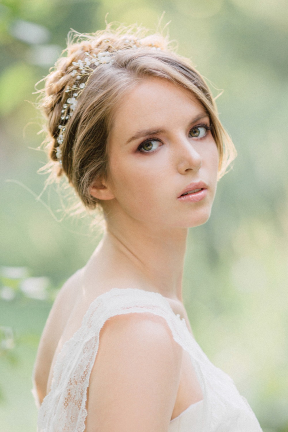 Elegant bride in lace dress with hair jewelry outdoor