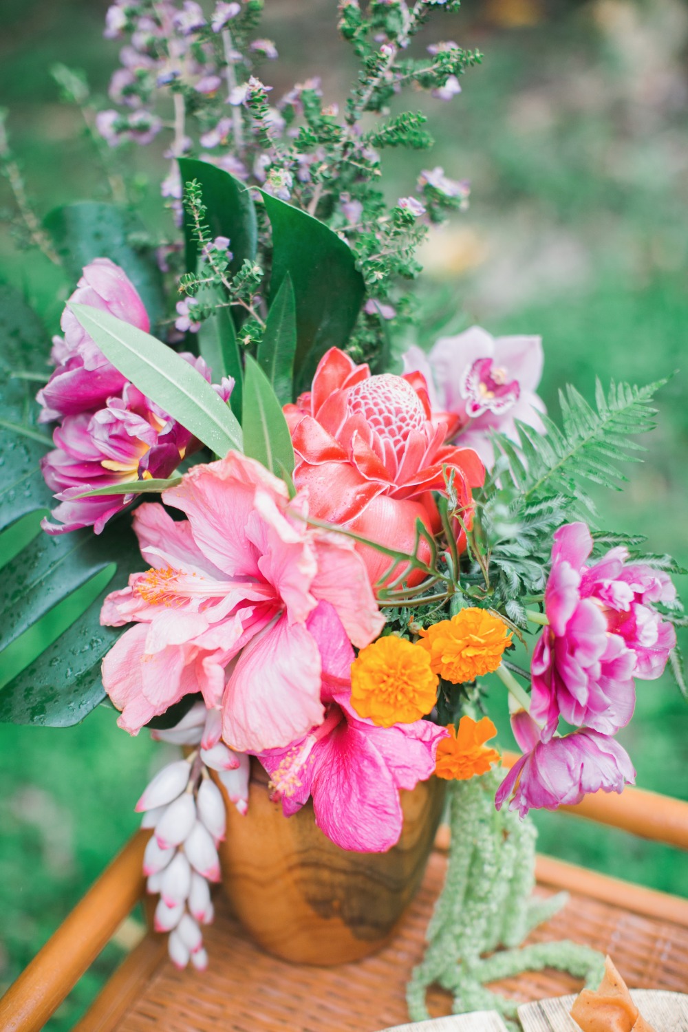Vibrant tropical flower arrangement in wooden vase
