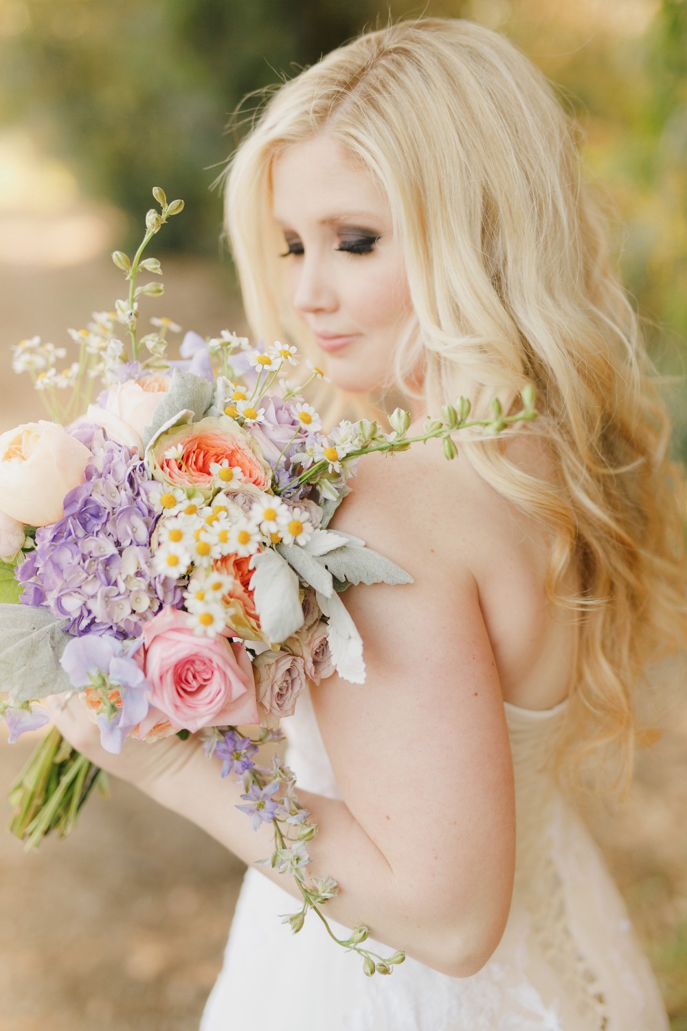 Radiant blonde bride with her colorful wedding bouquet