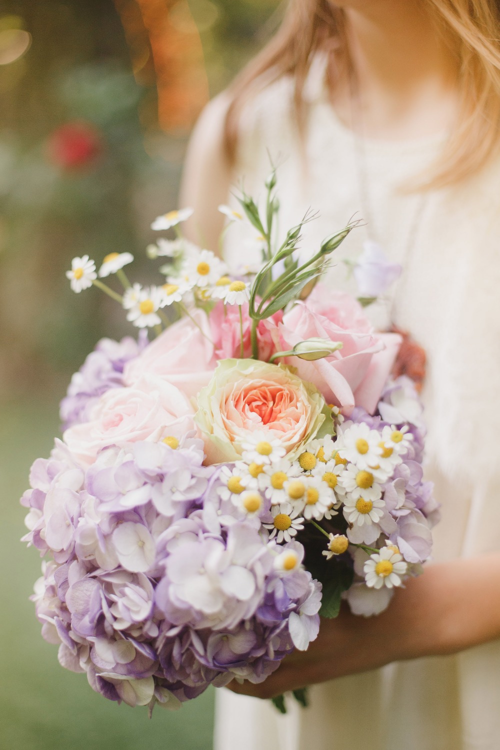 Woman holding a beautiful bouquet of colorful fresh flowers