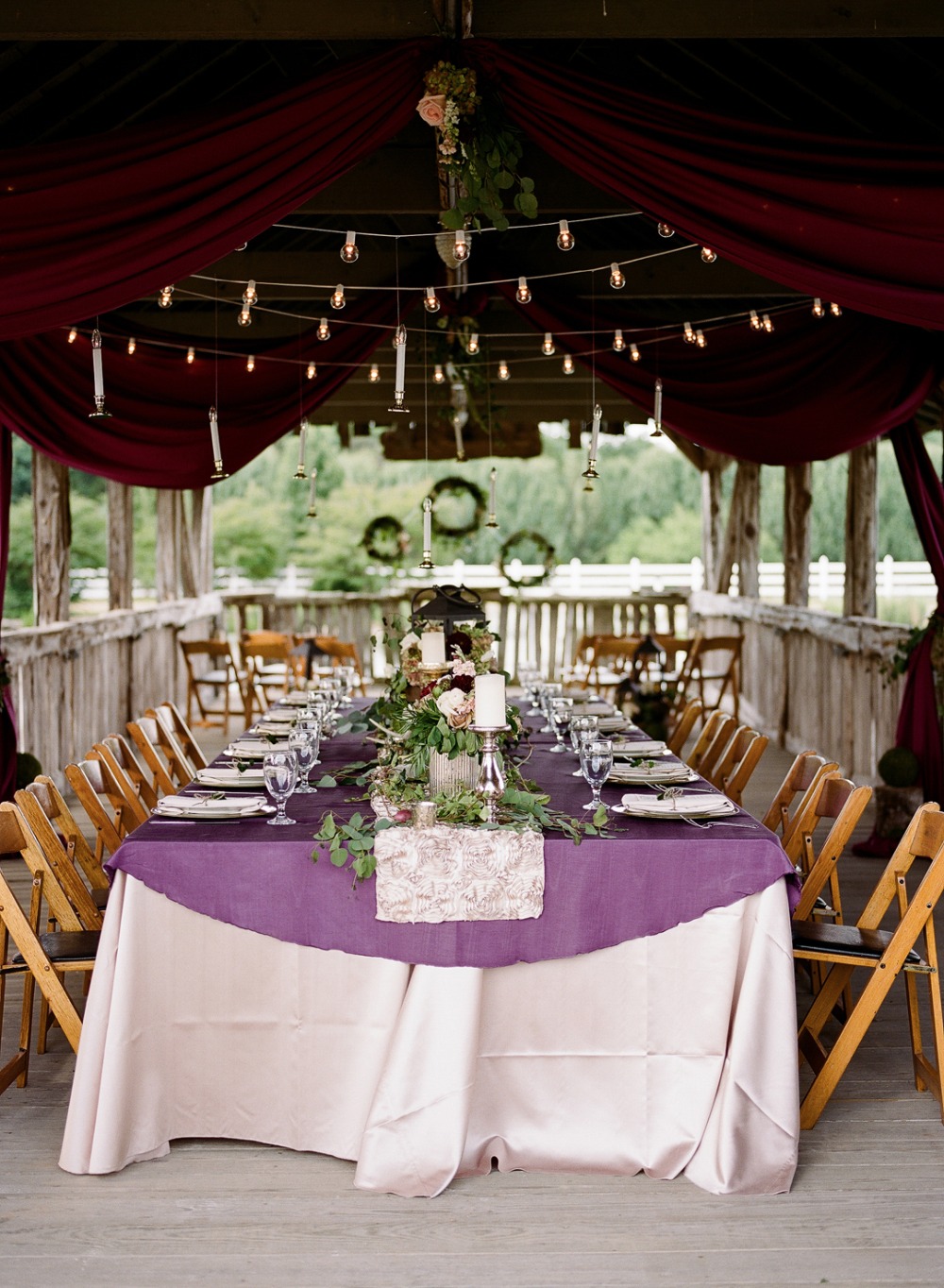 Elegant purple and maroon reception with hanging candles