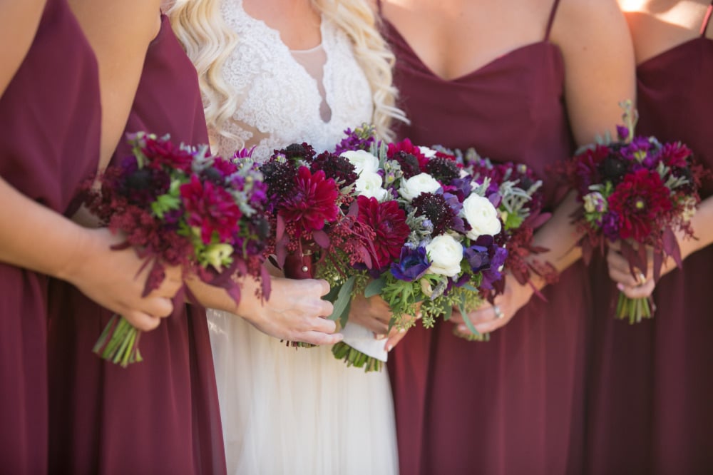 red bridesmaid dresses and bouquets