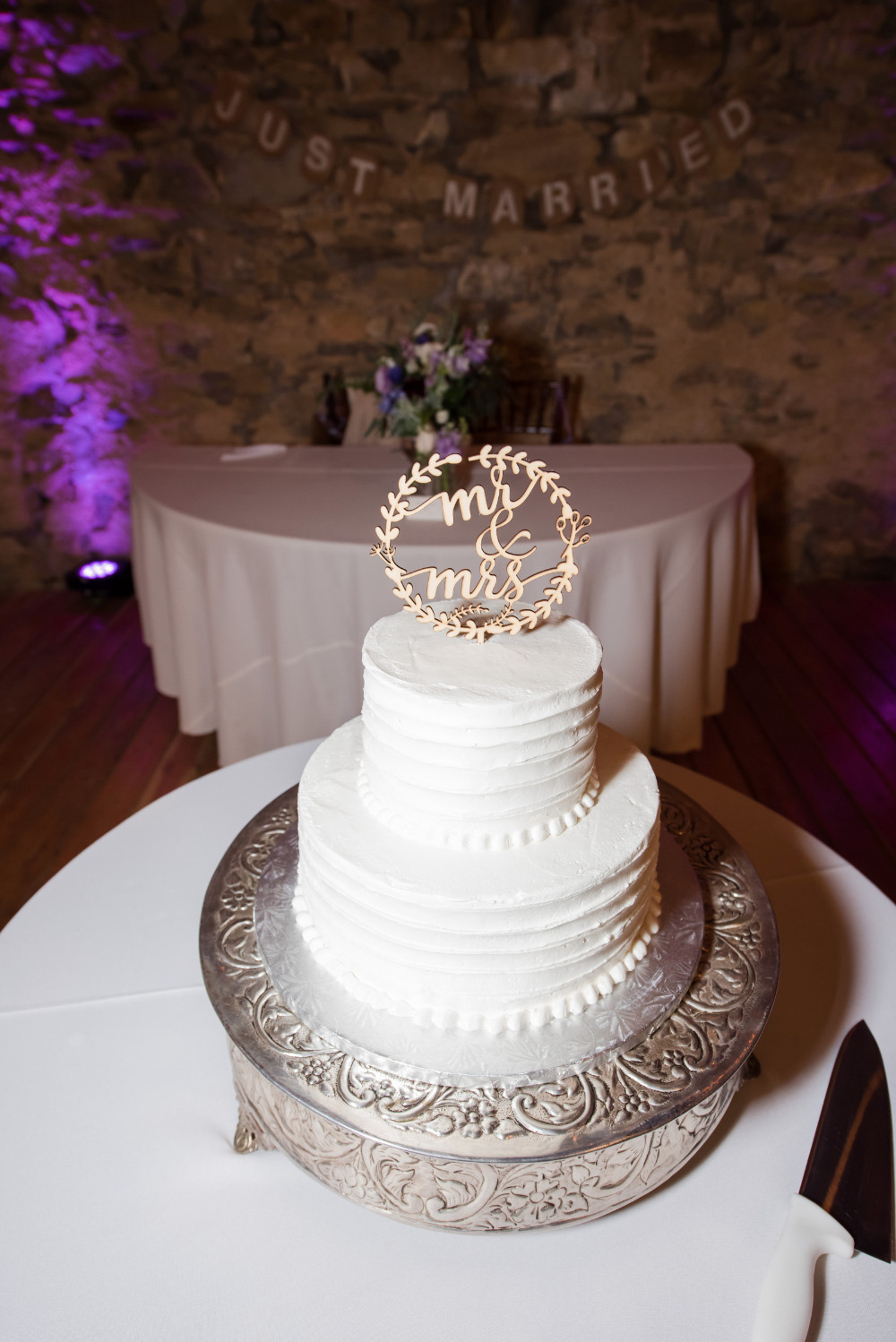 white rustic wedding cake with wood topper