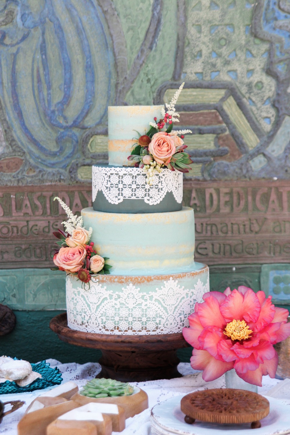 Blue nearly naked cake with lace and flowers