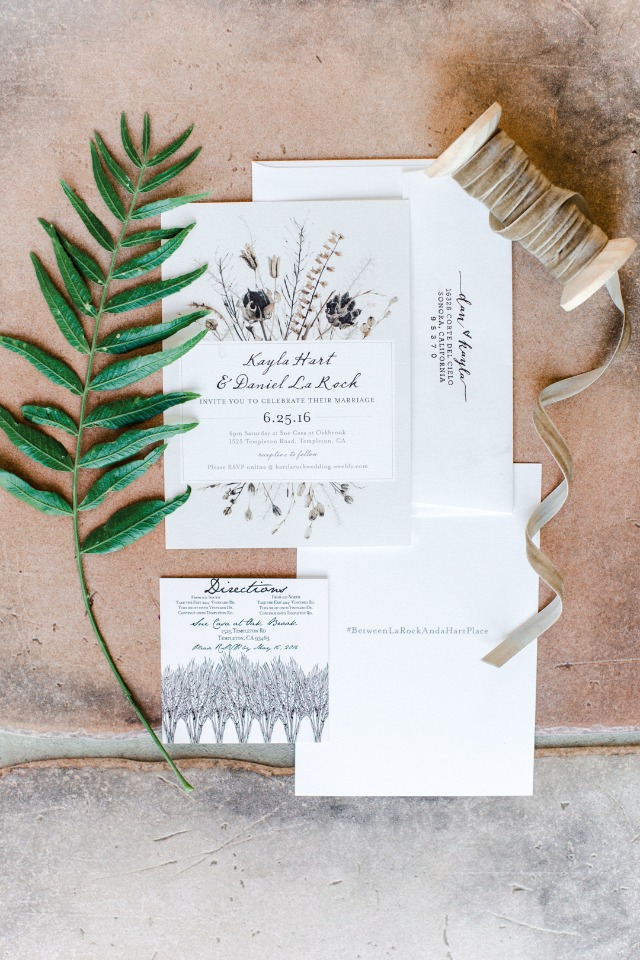 Wedding invitation suite with greenery and ribbon detail
