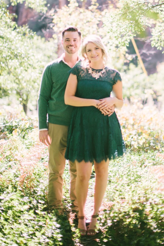 Happy couple smiling in green dress and sweater outdoors