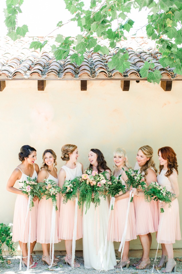 Bride and bridesmaids in pink dresses with bouquets