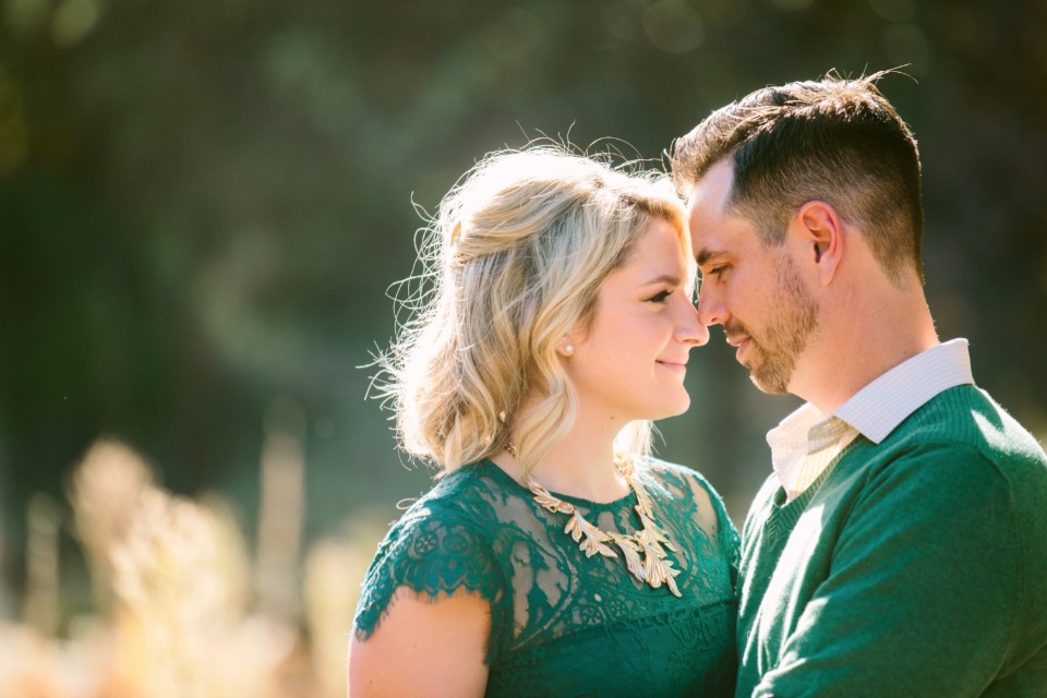 Engaged couple gazing lovingly at each other outdoors