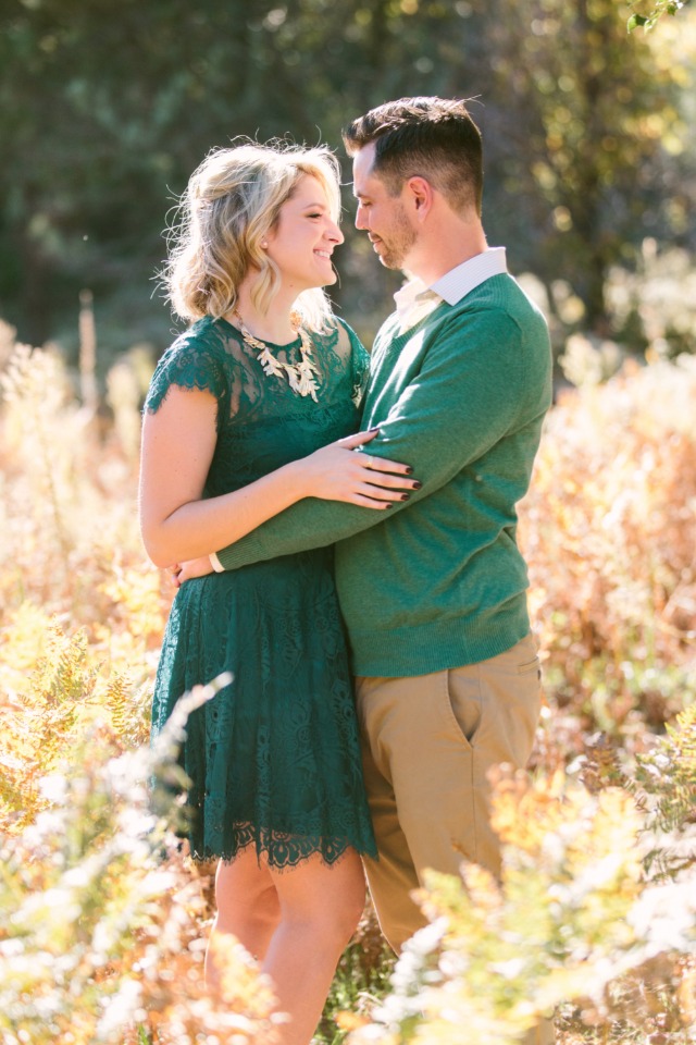 Couple in love embracing in nature smiling at each other