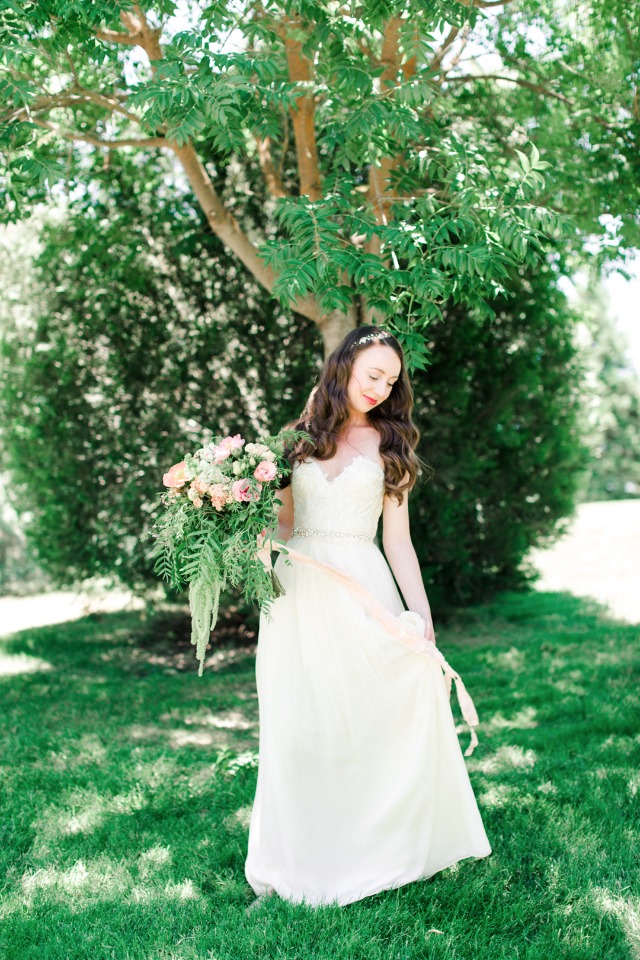 Bride with bouquet in garden wedding dress outdoors
