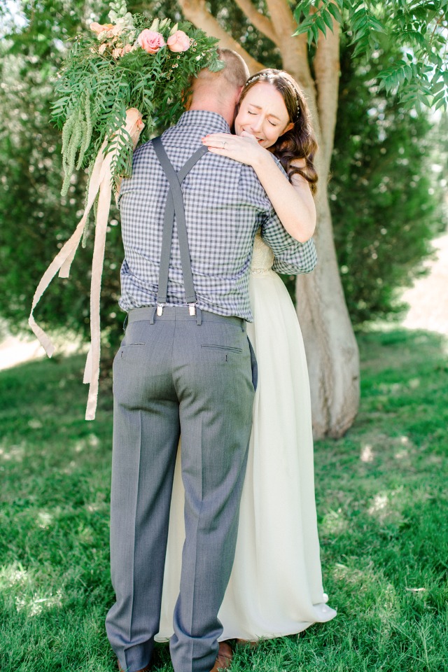 Emotional bride and groom embrace after wedding ceremony