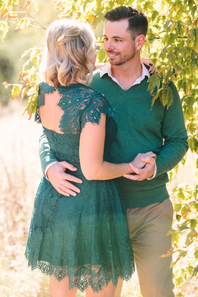 Romantic couple embracing outdoors in green clothing