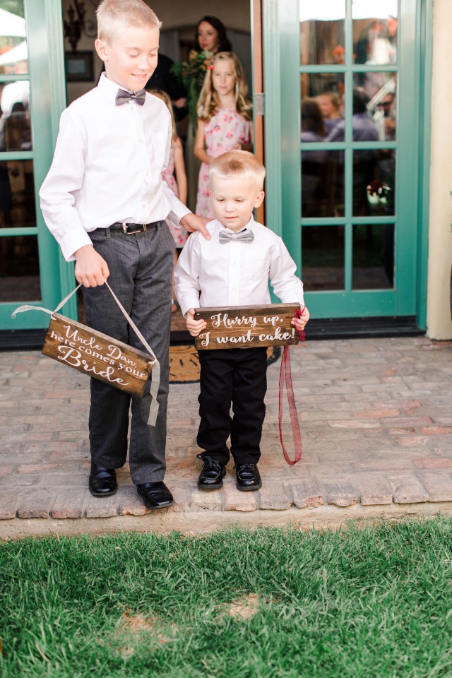 Ring bearers announce bride with cute wedding signs