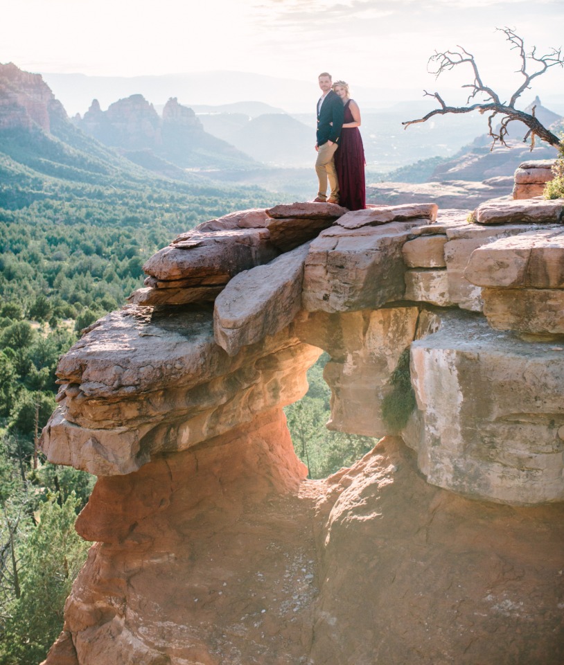 Couple enjoys scenic mountain vista from Sedona rock formation