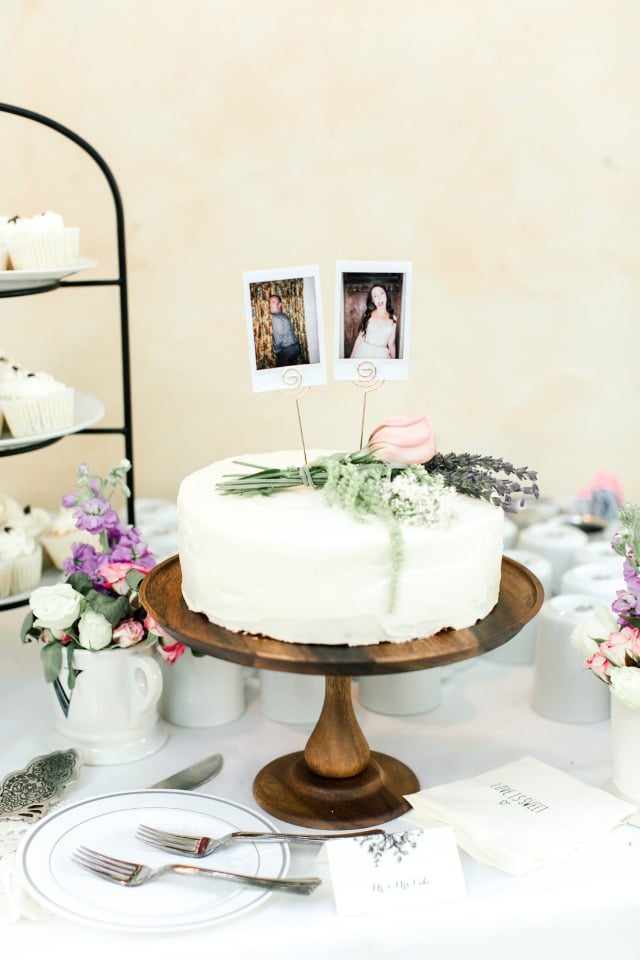 single tier wedding cake with simple and elegant flower accent and fun polaroid topper