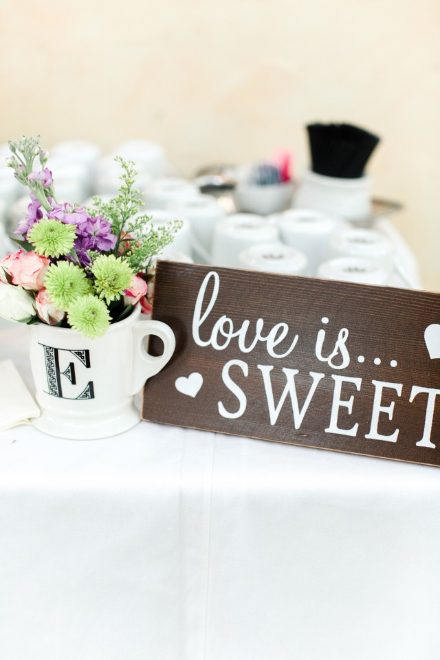 Wedding decor with a love is sweet sign and floral arrangement