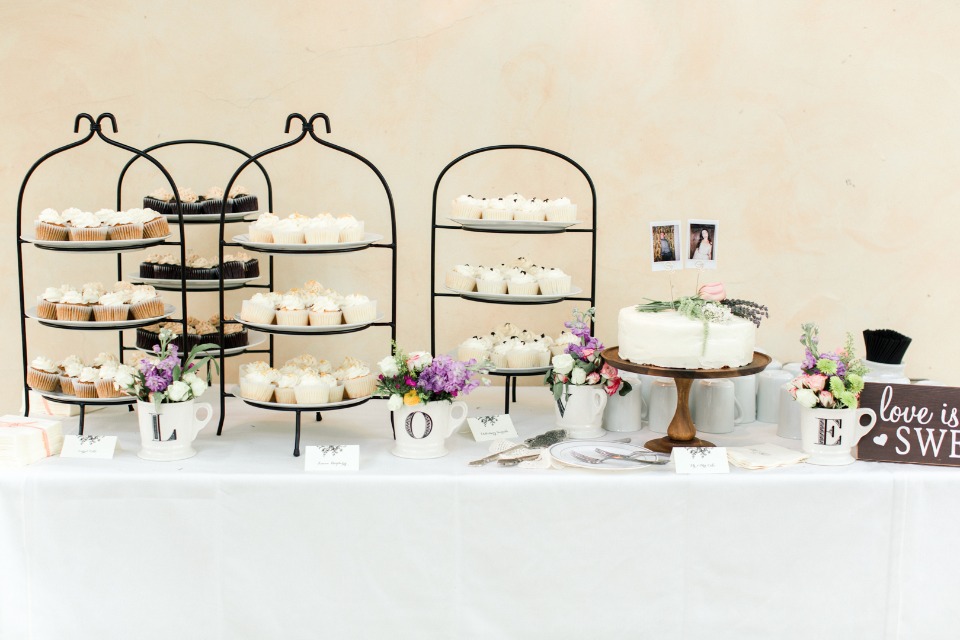 Elegant dessert table with cupcakes and wedding cake
