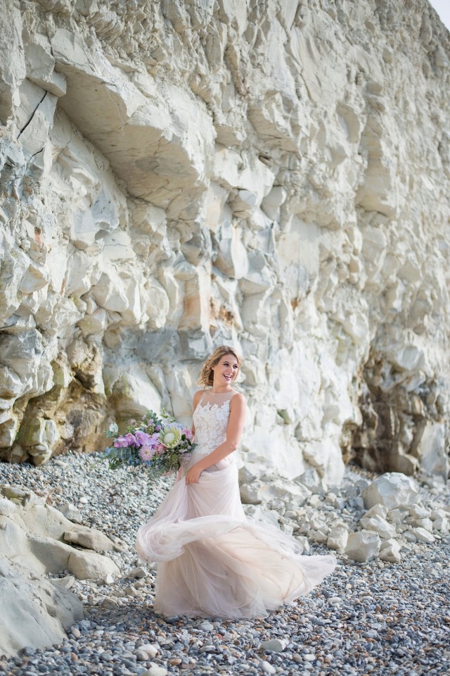 happy bride on a rocky beach
