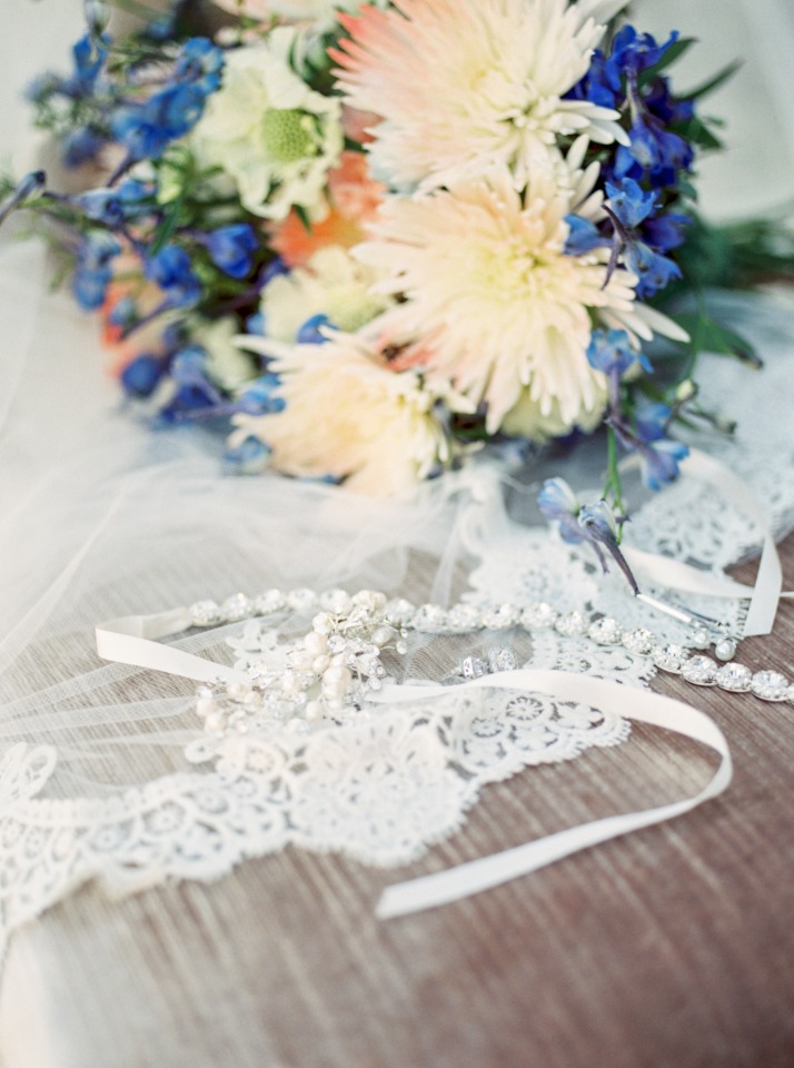 Wedding bouquet lace veil and jewelry closeup shot