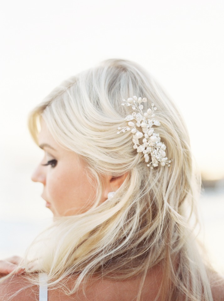 Blonde woman with pearl hair clip for wedding style
