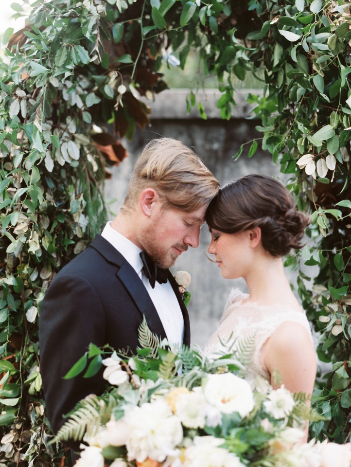 Loving couple embrace at a wedding ceremony in lush greenery setting