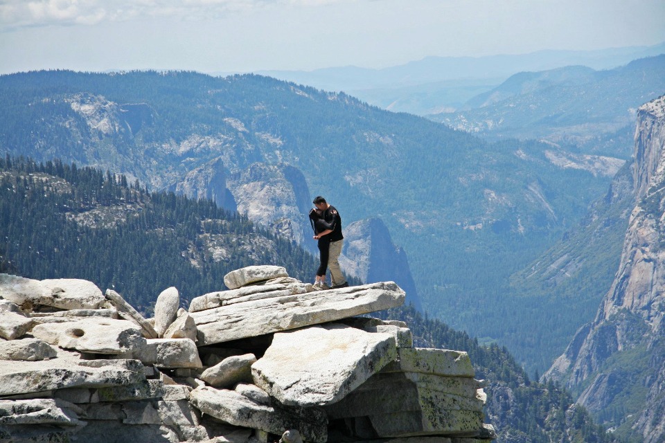 Couple embracing on Yosemite clifftop vista