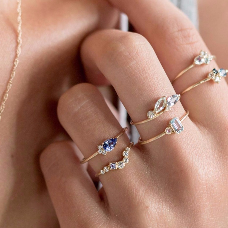 Delicate gold rings with blue and white gemstones