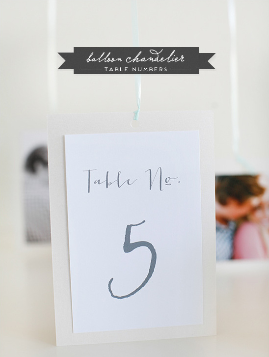 Hanging table number five at wedding reception decor