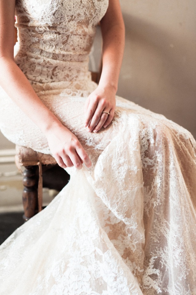 Bride in lace wedding gown with simple wedding ring