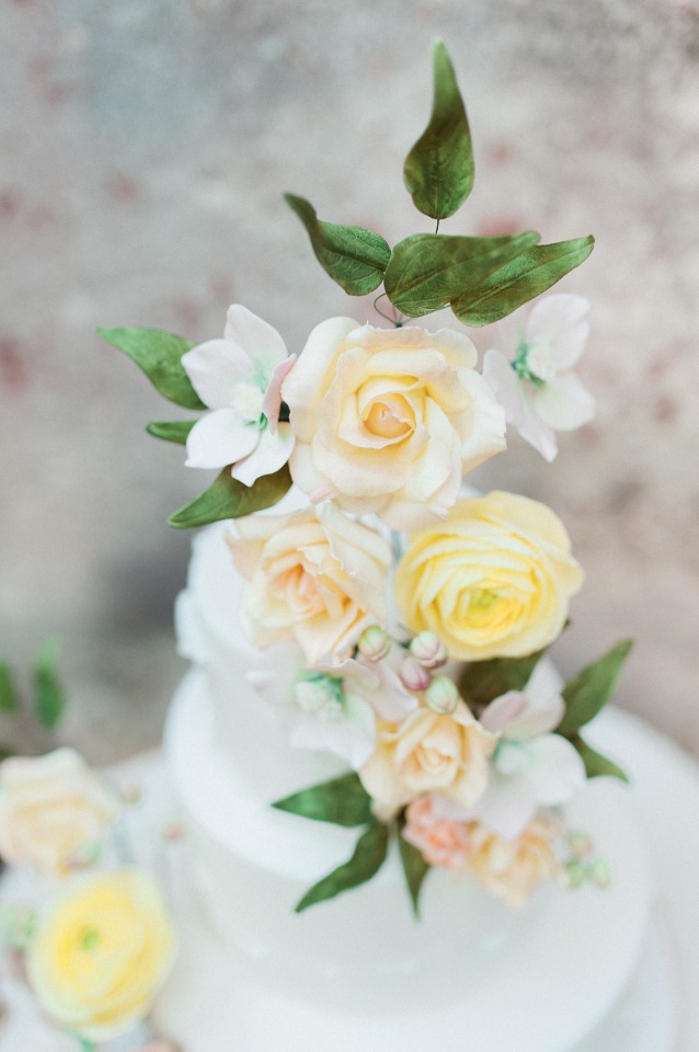 Elegant tiered cake with pastel floral decorations for wedding