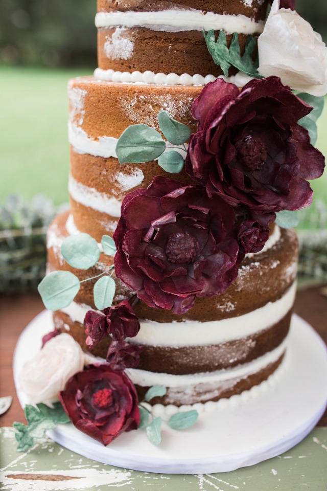 naked wedding cake with edible floral accents