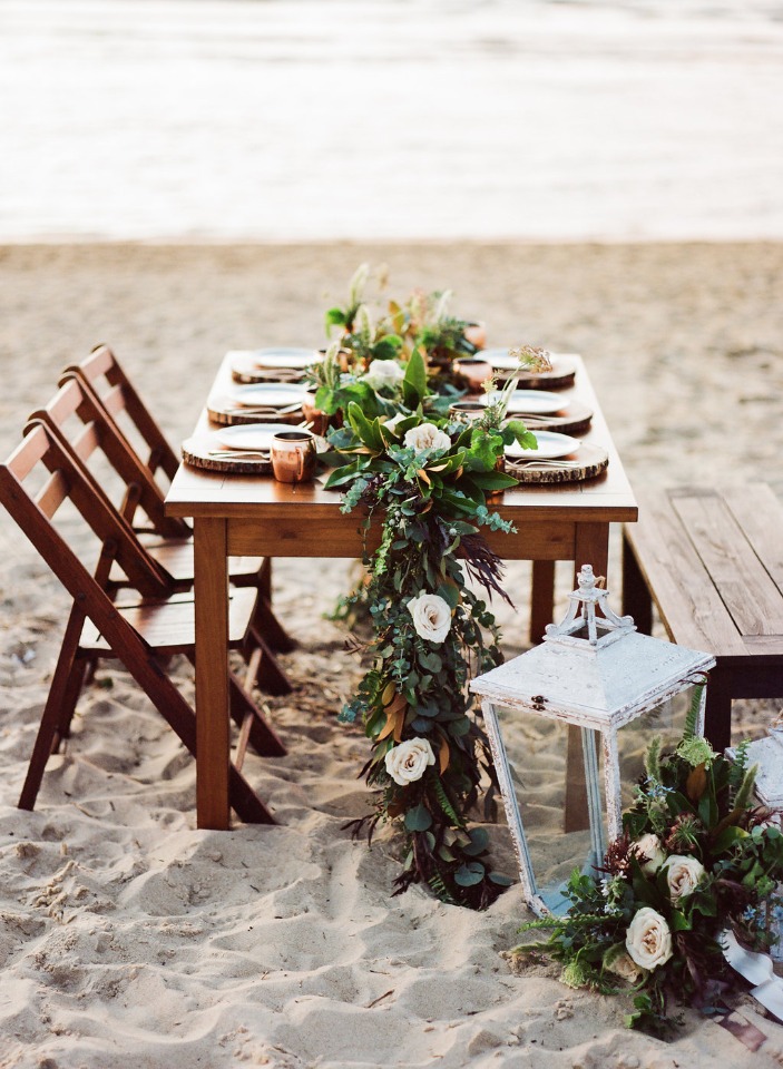 Beach wedding table decor with flowers and lantern outdoor