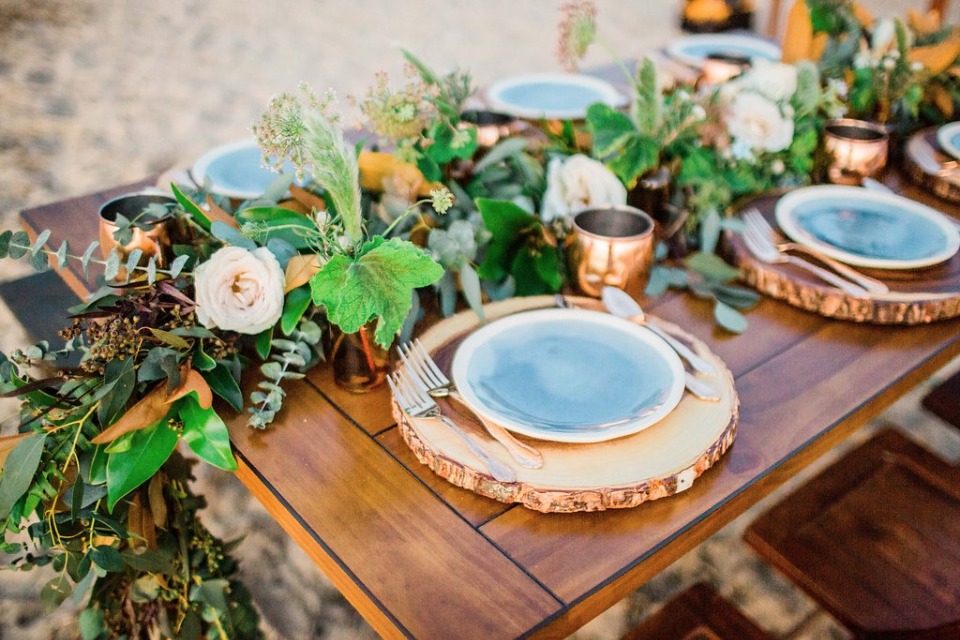 wooden slab chargers and greenery garland centerpiece table decor