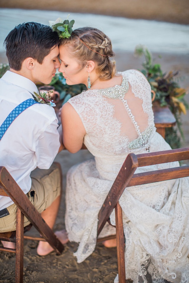 Romantic beach wedding couple tender moment bride dress